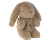 Mini cream peach colored plush bunny with bow around its neck. 