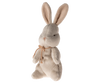 The Maileg My First Bunny - Dusty Rose, featuring soft plush fabric and large, upright ears, stands against a plain white background. Its simple stitched face and delicate rustic ribbon make it an ideal baby shower gift.