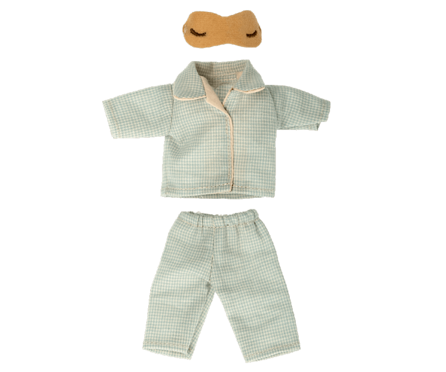 A small set of green-and-white checkered Maileg Extra Clothing: Pajamas for Dad Mouse with a collared top and matching pants, made from the softest cotton. An additional light brown eye mask with eye shapes drawn on it is also visible above the pajamas.