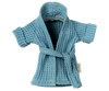 A small, blue, waffle-knit kids bathrobe with short sleeves and a belt tied at the waist. This soft Maileg Extra Clothing: Bathrobe - Dusty Blue appears designed for a child or a small stuffed animal, featuring a textured fabric and a mini tag on the left side.