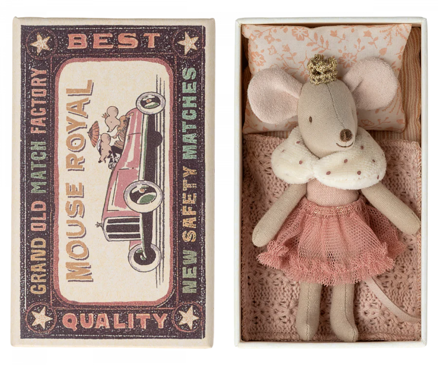 An antique matchbox labeled "Maileg Princess Little Sister, Mouse - Rose" next to a small, crafted mouse doll wearing a pink skirt and white collar, placed inside an open matchbox lined with pink bed linen.