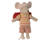 A Maileg Hiker Mouse, Big Sister from the hiker collection, wearing a patterned beanie, a sweater with a yellow and orange design, pink shorts, and carrying a red backpack. The beige-bodied mouse stands upright, ready for its next hiking trip into the wild nature.