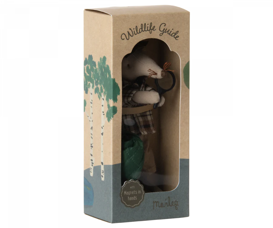 A Maileg Wildlife Guide Mouse toy inside a display box labeled "Wildlife Guide" by Maileg, featuring a clear plastic front and cardboard sides with tree designs. The toy mouse has a magnet in