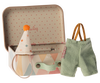 A small metal suitcase with a pastel diamond pattern is open, revealing a polka-dotted interior. Next to the suitcase, there is a small, pointy hat with a pompom on top and a pair of tiny green overalls with suspenders, perfect for Maileg Clown Clothes In Suitcase, Little Brother Mouse.