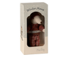 A small winter mouse toy, part of the Maileg Winter Mouse with Ski Set, Big Sister - Rose, dressed in a red knitted sweater and plaid pants, comes enclosed in packaging decorated with snowy designs. The box is labeled "Winter Mouse" and "Big Sister," featuring the brand name "Maileg" at the bottom. It’s crafted from recycled polyester for an eco-friendly touch.