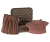 A small metal suitcase is open, revealing a striped skirt and a pink knitted sweater inside. The suitcase, perfect for Maileg Knitted Blouse And Skirt In Suitcase, Grandma Mouse or any holiday toy, features a floral design on the interior and has the label "Maileg" on the lid.