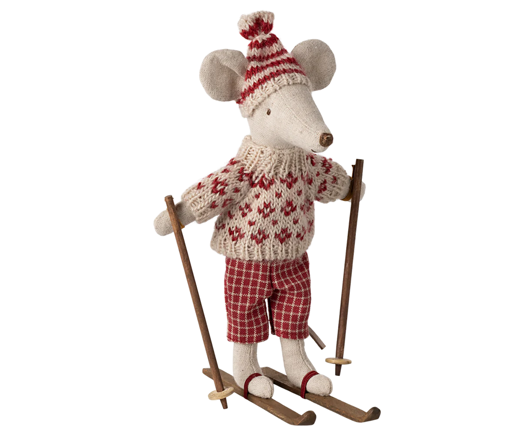 The Maileg Winter Mouse with Ski Set, Mom - Red features an adorable stuffed mouse toy adorned in a red and white knitted sweater, patterned pants, and a matching hat, all while standing on wooden skis as part of the winter toy collection.