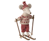 The Maileg Ski Lounge Set features an adorable stuffed mouse toy outfitted in a cozy knitted red and white sweater, a matching hat, and checkered pants. The mouse stands confidently on skis with wooden poles, making it perfect for display. However, please be aware that it contains small parts and may pose a choking hazard for young children.