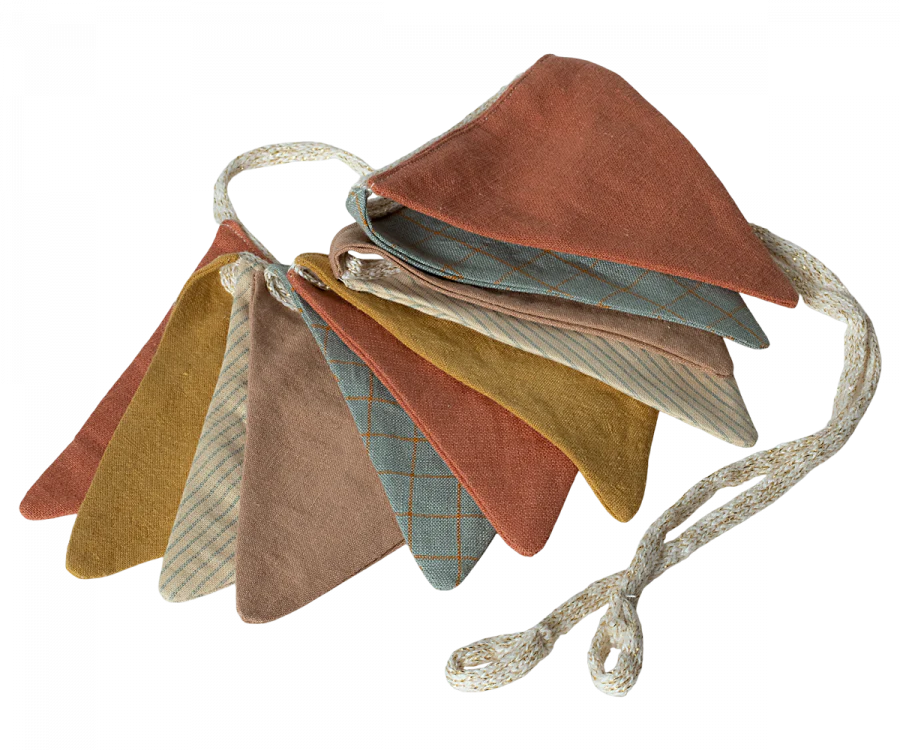 A festive Maileg Garland - Multi of fabric bunting flags in multi-colored fabrics, including brown, yellow, blue, and beige. The triangular flags are made of cloth with different textures and patterns, some featuring stripes or checkered designs. Perfect for playrooms and nurseries, the Maileg Garland - Multi is coiled loosely on the surface.