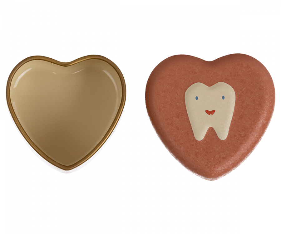 Two heart-shaped objects are shown. The one on the left is a golden metal heart-shaped container with an open lid. The one on the right is a Maileg Tooth Box with a smiling tooth illustration on the surface, evoking childhood memories of small baby teeth.