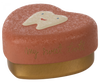 A Maileg Tooth Box with a textured surface. The lid is a light coral color and features a cute tooth illustration with a smiling face. The words "My sweet tooth" are printed in gold script on the side, perfect for holding small baby teeth and cherished childhood memories.