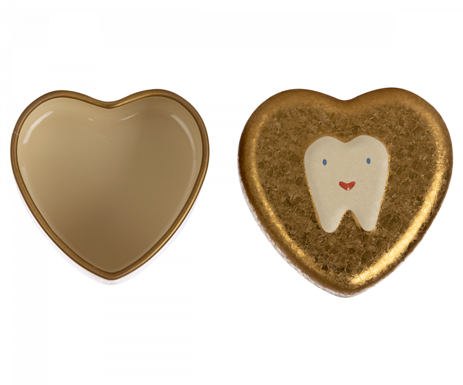 Two heart-shaped objects. The one on the left is a plain, glossy heart. The one on the right is a Maileg Tooth Box, a textured, gold-colored metal heart keepsake with an illustration of a tooth that has a smiley face on it.