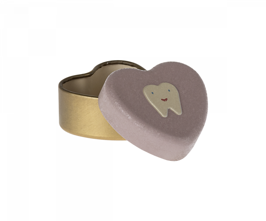 A small, heart-shaped Maileg Tooth Box with a beige base and a pink lid adorned with a smiling tooth illustration. The lid is partially open, revealing the empty inside of the container, perfect for storing small baby teeth and preserving childhood memories.