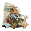 The Jurassic Stacking Dinosaurs set, made from FSC-certified wood, showcases uniquely painted dinosaurs in front of a "Dinosaurs Stacker Tower" drawstring bag adorned with dinosaur images.