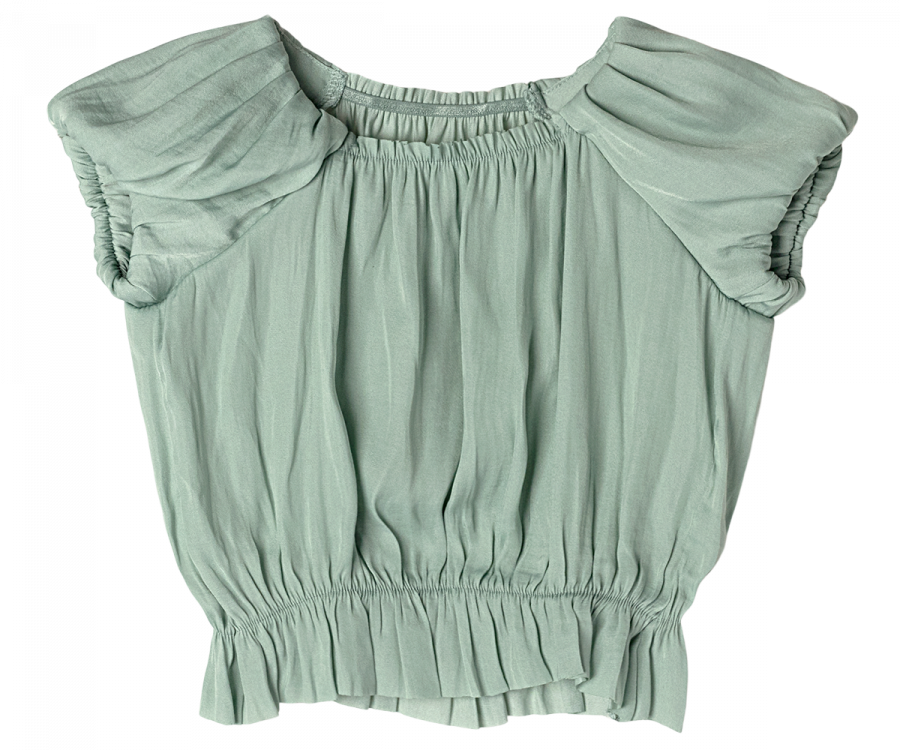 A light green, short-sleeve Maileg Princess Blouse - Mint (Final Sale) with gathered detailing. Crafted from exclusive materials, it features a round neckline and ruffled, slightly puffed sleeves. The waistband and hem are also gathered, giving a flowy and textured appearance perfect for any fairytale dream.