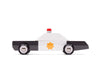 The Candylab Police Cruiser, a minimalist toy police car made of solid beech wood, is showcased on a white background. The vehicle features a black and white color scheme with a yellow star emblem on the door and a small red light on the roof. Its black and silver wheels are equipped with safety-tested rubber tires, adding to its simple and clean design.