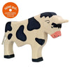 A handcrafted wooden toy cow with a white body and black spots. It features a prominently visible udder and a pink snout. Simply crafted with minimal detail, this charming piece from the Holztiger Bull collection includes an orange "spiel gut" sticker in the top left corner, recommending it for children's play.