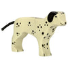 A handcrafted wooden Holztiger Dalmatian Dog painted in a creamy white color with black spots. Made from high quality maple and beech wood, the dog has black ears and a black tail, standing on four legs with a simple, stylized design.