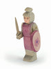 The Ostheimer Red Knight - Standing is a beautifully handcrafted wooden figurine dressed in intricate pink armor adorned with floral designs. This knight, holding a sword in one hand and a shield decorated with a delicate pink flower in the other, is perfect for imaginative play. Ready to inspire adventure, this charming toy stands majestically on a plain white background.