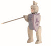 The Ostheimer Blue Knight - Riding is a handcrafted wooden toy figure reminiscent of classic Ostheimer toys, dressed as a medieval knight. Wearing a helmet and wielding a long spear in one hand and a purple shield adorned with a fleur-de-lis in the other, this figure encourages imaginative play with its painted facial features and jointed limbs.