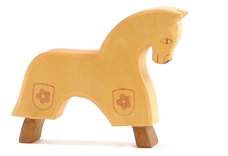 The Ostheimer Yellow Horse for Knight is a handcrafted light wooden toy that features minimalistic design and a smooth finish. It has two shield-like symbols engraved on its body and stands on four curved legs. Designed in a simple, blocky style with a short neck and tail, this horse is perfect for imaginative play.