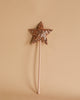 A single Magic Wand - Pink Sequin Star from Luciole et Petit Pois on a beige background. The wand has a long, thin handle and a star-shaped, sequin-covered top. The elegant piece is centered in the image against the plain, neutral backdrop.