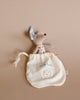 A small fabric pouch labeled "milk tooth" with a tooth illustration, accompanied by a Maileg Tooth Fairy Little Mouse wearing a polka-dotted shirt and a pointy hat, partially sticking out of the cute little bag on a beige background. Perfect for keeping those precious baby teeth safe until the tooth fairy arrives.