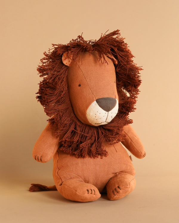 The Maileg Lion Stuffed Animal, featuring a fuzzy mane and handmade details, sits against a neutral background, perfectly embodying the charm of safari friends.