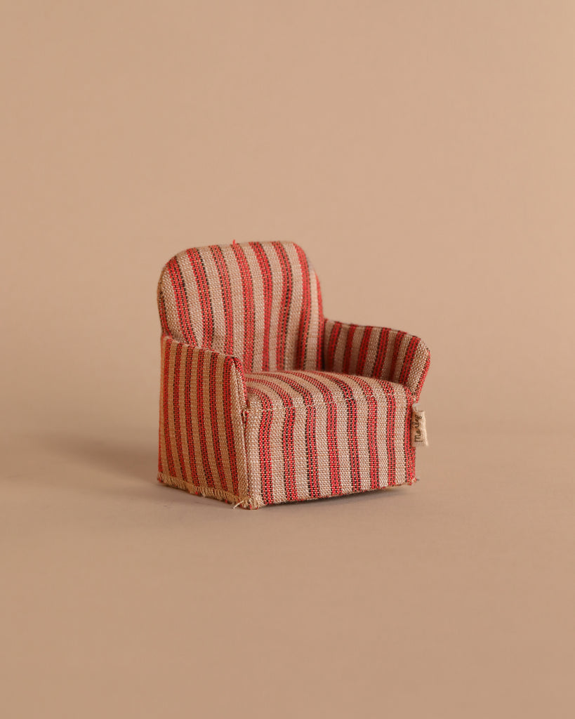 The Maileg Chair, Mouse - Striped, boasts a red and beige striped pattern and sits elegantly against a plain beige background, creating a cozy spot for Maileg friends.