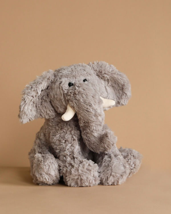 Jimmy the Elephant Stuffed Animal is a soft and snuggly toy with tusks, ideal for children from birth onward. Designed to be gentle and cuddly, it's perfect for little ones. Additionally, it retains its charm even after a gentle cold machine wash.