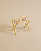 A small, yellow Maileg Drying Rack, Mouse Size with small wooden pegs attached to its bars is positioned against a plain beige background. The drying rack is empty, with no clothing or items hanging on it.