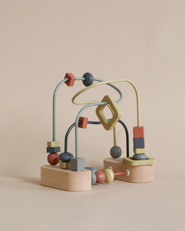 A colorful Wooden Activity Beads toy with looping metal tracks and various shaped beads, set against a plain beige background.