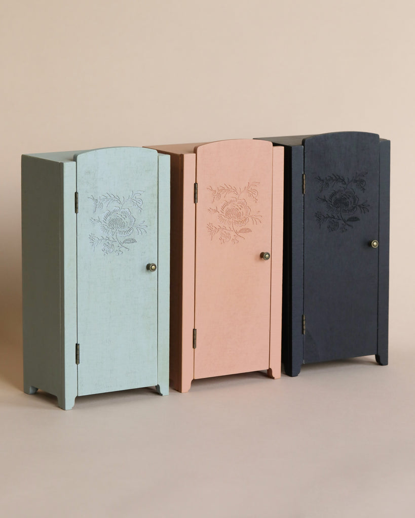 Three Maileg Miniature Closets in pastel shades of green, pink, and blue, each featuring printed floral details, displayed against a neutral background.