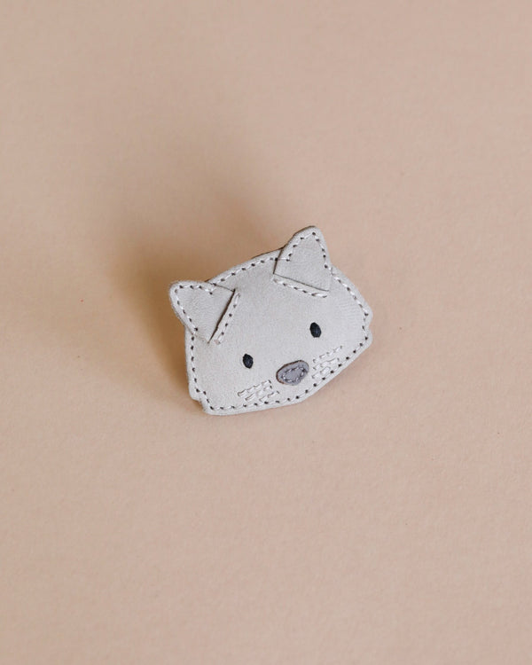 Handmade white fox-shaped Donsje Leather Hair Tie - Cat with stitched details and a neutral background.