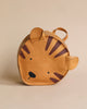 A children's backpack designed to look like a tiger's face, featuring ears and stripes in a Donsje School Leather Backpack - Tiger design, displayed against a neutral beige background.