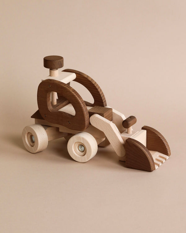 A Goki Bulldozer made of sustainable raw material, featuring a propeller and movable wheels, displayed against a neutral beige background.