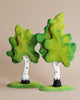 Two Extra Large Wooden Trees (set of two) with green leaf canopies and white trunks marked with black stripes, crafted from linden wood, positioned against a beige background.