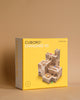 A Cuboro 50 Marble Run Starter Set box featuring a wooden marble track system on a neutral beige background. The box is primarily yellow with a clear product image and logos.