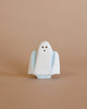 A Handmade Wooden Ghost with light blue accents stands against a plain beige background. The ghost figurine has two black dots for eyes and a small black dot for a mouth, giving it a simple, minimalist appearance, perfect for sparking a spooky story during playtime adventure.