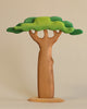 A Extra Large Wooden Tree resembling a tree, crafted from linden wood, with a trunk that seamlessly transitions into exaggerated, rounded branches topped by a flat, green canopy, all set against a neutral background.