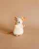 A plush toy resembling a Pilla Mouse Stuffed Plush Animal by Steiff with high quality woven fur stands upright against a solid beige background, featuring large eyes and a bushy tail.