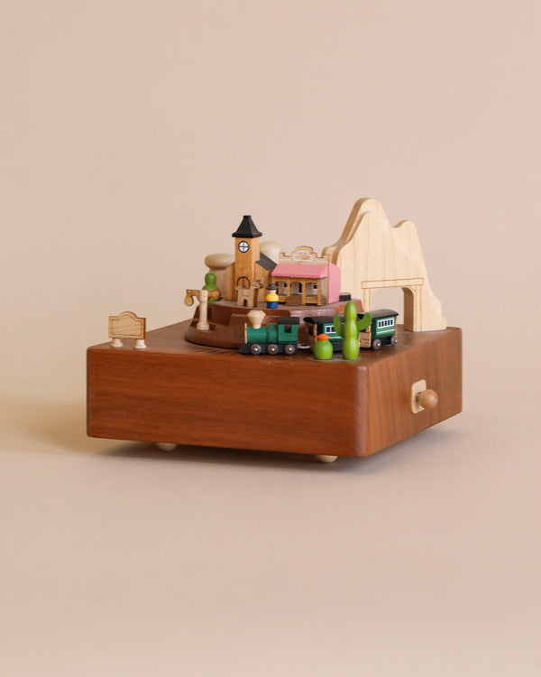 Wooden music box with the theme of a Western town and a train going around