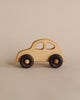 A simple Wooden 1930s Car made from FSC certified wood, with a natural beeswax finish and dark wheels, positioned on a light beige background.