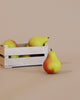 Three Erzi Pear Green-Red Pretend Food, two inside a small wooden crate and one in front, on a plain beige background, all handcrafted toys from Erzi.