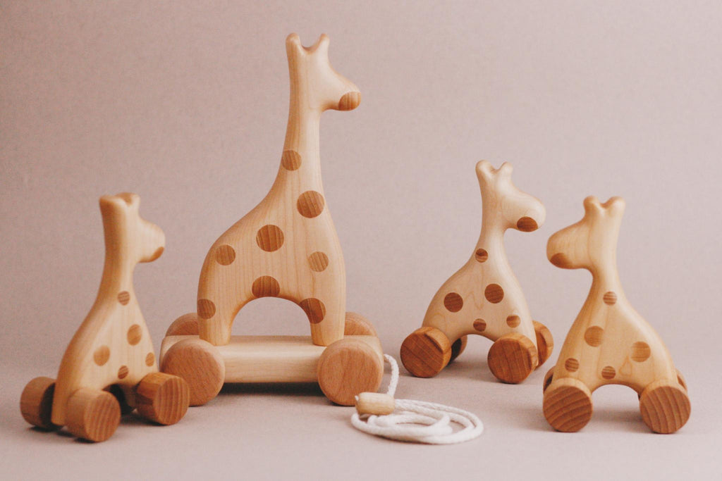 Introducing the Handmade Wooden Mini Giraffe Push Toy, a delightful addition to any imaginative play collection with its charming handcrafted design on wheels.