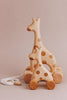 The Handmade Wooden Mini Giraffe Push Toy boasts vibrant colors and smooth wheels, making it perfect for little adventurers.