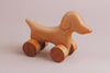 The Handmade Wooden Mini Dog Push Toy is expertly crafted from maple and beech wood, offering hours of playful fun.