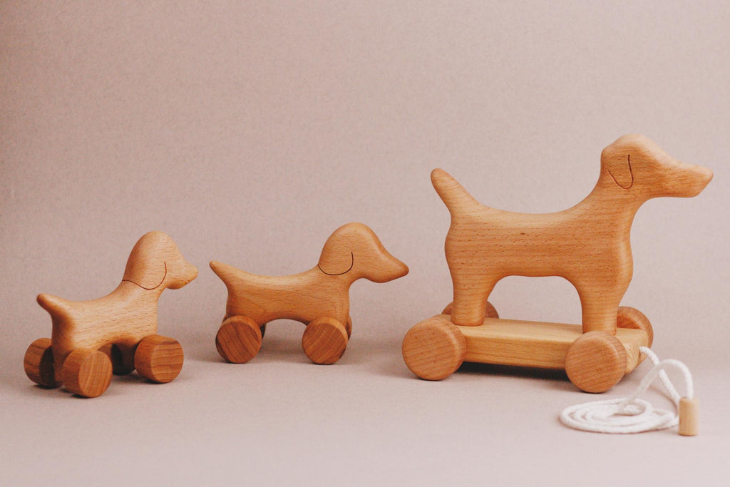 A delightful handmade push toy featuring a mini dog design, crafted from maple and beech wood, elegantly created for endless playtime adventures.