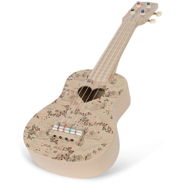 The Konges Sløjd - Wooden Ukulele - Mizumi features a beige, FSC-certified wooden body embellished with floral designs. While the fretboard is plain, the headstock includes tuning pegs. Delicate flowers alongside the words "ma mélodie" near the bridge beautifully merge nature and melody.