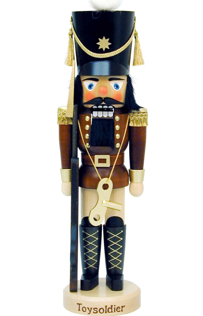 A limited edition Christian Ulbricht nutcracker, styled as a Toy Soldier, showcases a tall black hat with gold trim, a brown uniform decorated with gold buttons, and includes a faux rifle. The base is elegantly engraved with "Toysoldier.